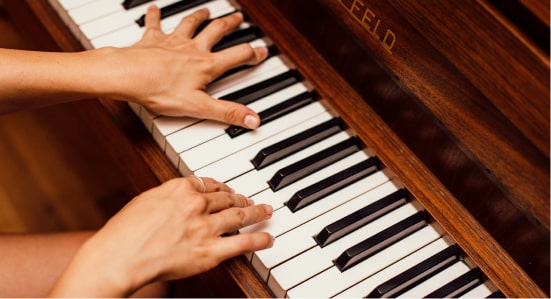 Les mains d'une personne qui joue du piano.